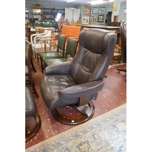 391 - Stressless style brown leather reclining swivel armchair together with matching foot stool