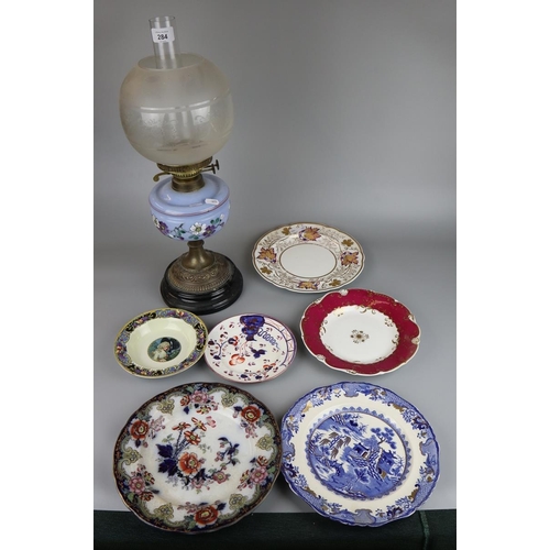 284 - Oil lamp together with a collection of cabinet plates