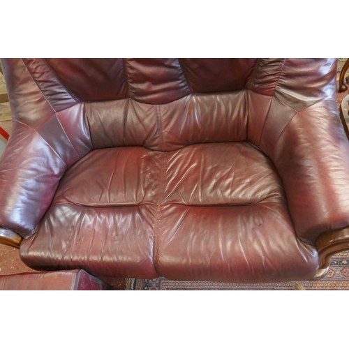 508 - Oak framed leather two seater sofa together with foot stool and bamboo magazine rack