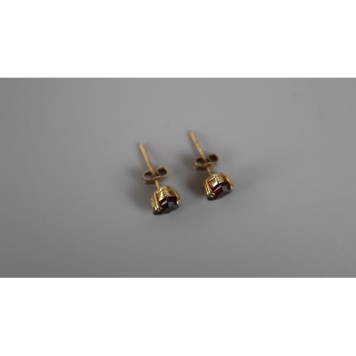 28 - Pair of gold garnet set earrings