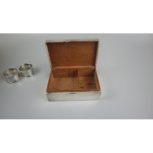 3 - Hallmarked silver cigarette box together with silver napkin rings