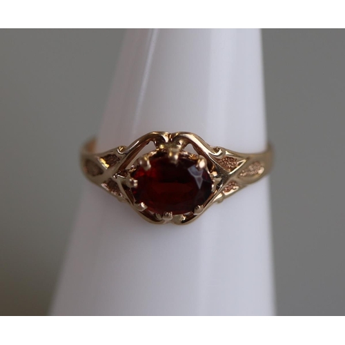 116 - Gold child's garnet set ring - Size J½