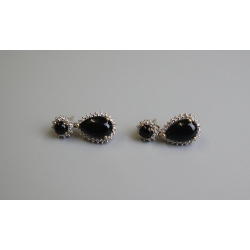 148 - Pair of gold cabochon garnet & diamond set earrings