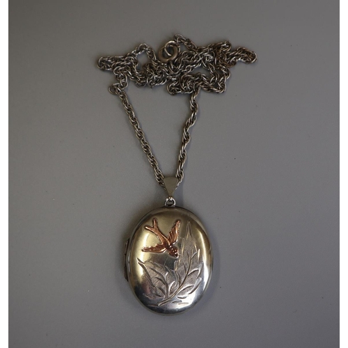 68 - Silver locket with inset gold bird on silver chain