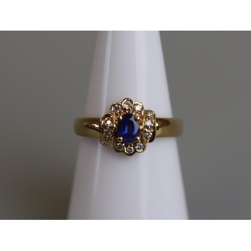 81 - 18ct sapphire & diamond set ring - Size M