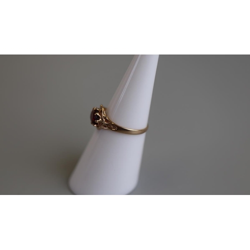 116 - Gold child's garnet set ring - Size J½