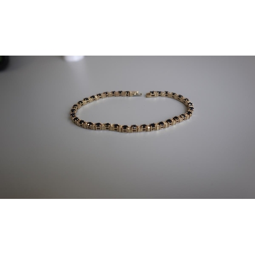 209 - Gold sapphire & diamond tennis bracelet