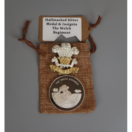 114 - Hallmarked silver medal & insignia - The Welch Regiment