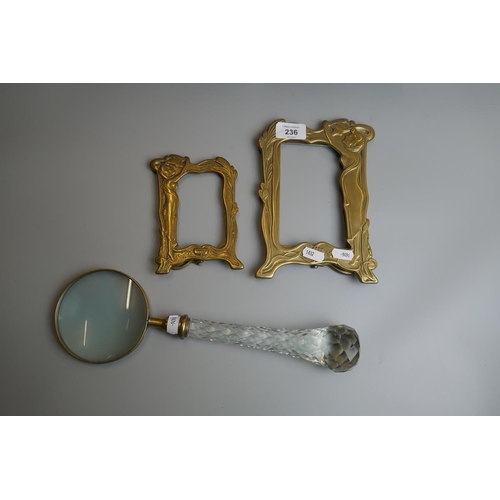 236 - 2 Art Nouveau brass photo frames together with a large magnifying glass with cut glass handle