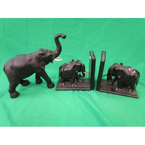 271 - Pair of carved hardwood elephant book ends together with a Libertys style leather elephant figure