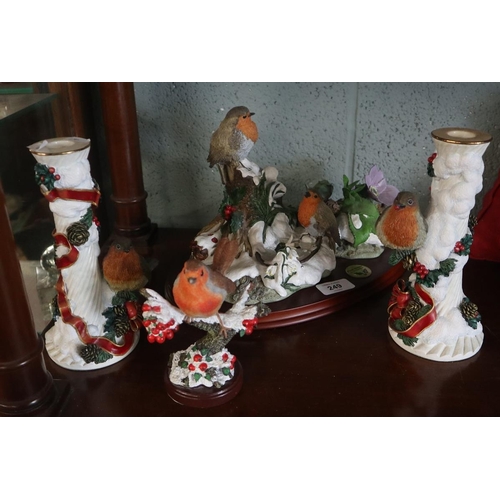 249 - Collection of robin ornaments to include a pair of Christmas candlesticks