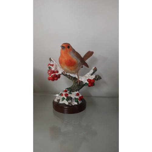 249 - Collection of robin ornaments to include a pair of Christmas candlesticks