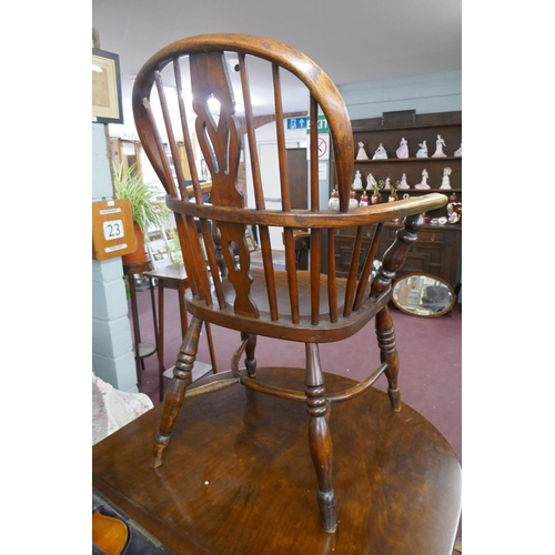 264 - Early comb back elm seated armchair with crinoline stretcher