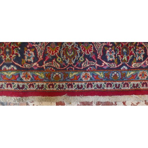 351 - Large red patterned wool rug - Approx size: 290cm x 188cm
