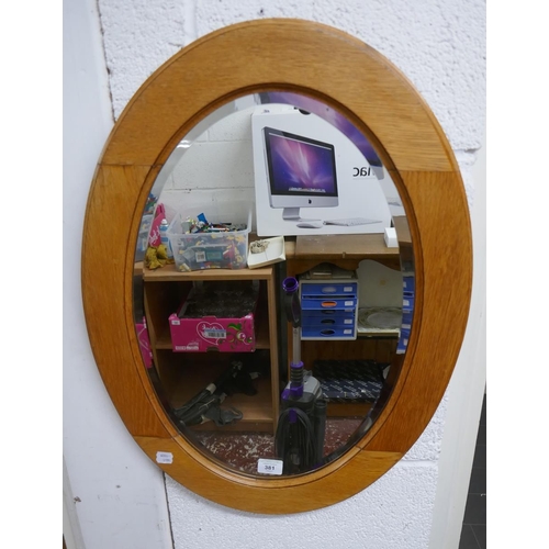 381 - Oak oval mirror with bevelled glass