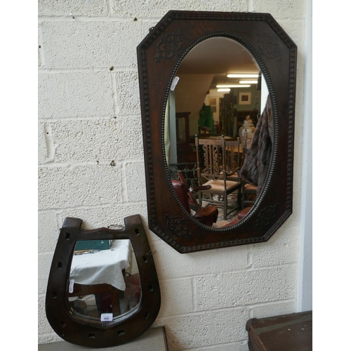 468 - Black octagonal oak framed wall mirror together with an oak framed horseshoe mirror