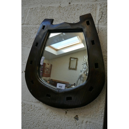 468 - Black octagonal oak framed wall mirror together with an oak framed horseshoe mirror