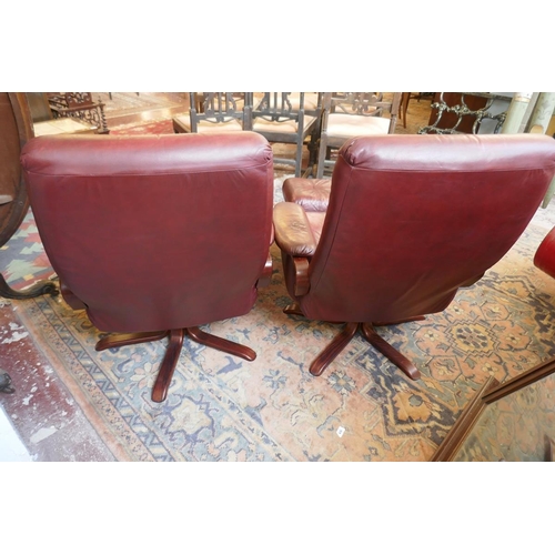 473 - Pair of leather mid century swivel recliner chairs with stools