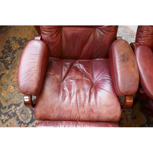 473 - Pair of leather mid century swivel recliner chairs with stools