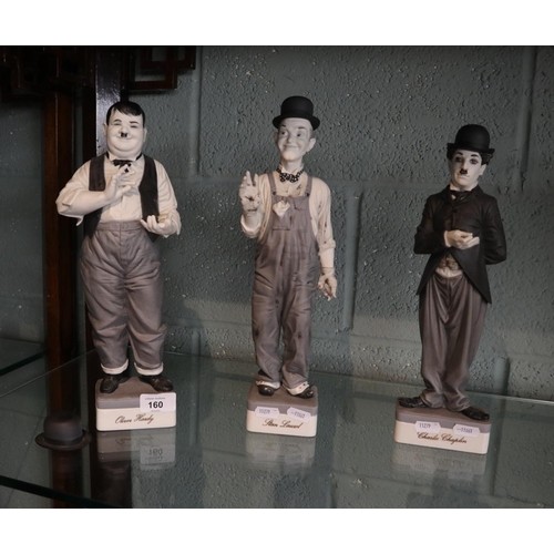 160 - Porcelain figurines - Laurel and Hardy and Charlie Chaplin A/F - Approx height of tallest 35cm