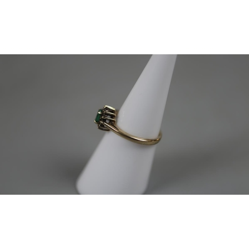 33 - 9ct gold emerald and diamond cluster ring - Size K