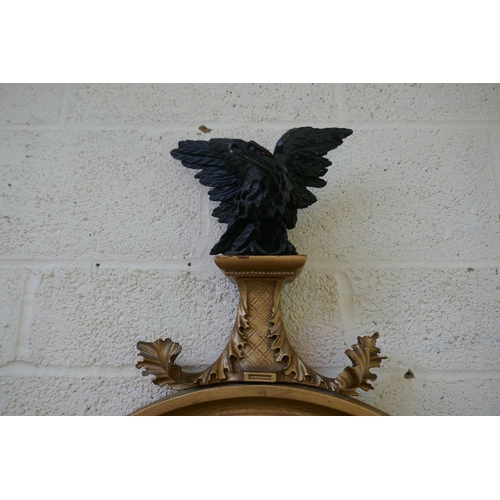 383 - Gilt framed round mirror adorned with eagle