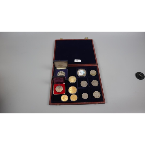 63 - Collectors coins in display case