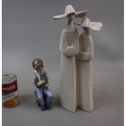 140 - Lladro porcelain figurine of nuns and a Nao seated child