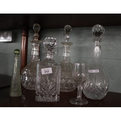 212 - Collection of cut glass decanters together with an antique perfume bottle