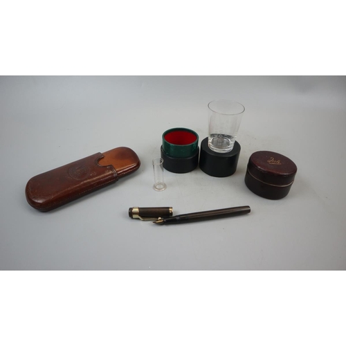 102 - Leather cigar case, Waterman fountain pen, Victorian travelling ink well & medicine glass in cas... 
