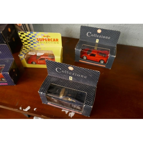97 - Collection of Ferrari models in original boxes together with folder