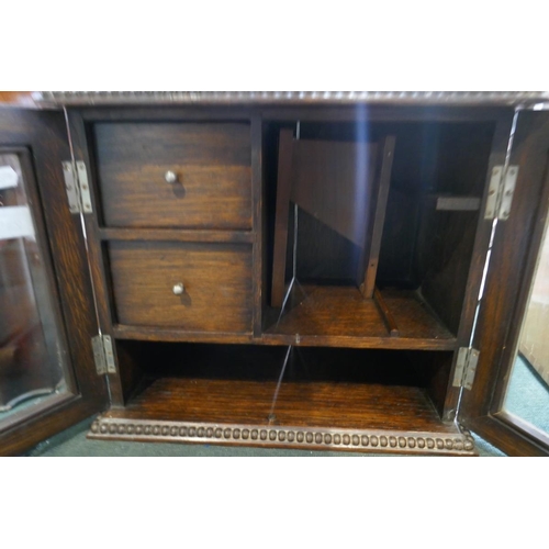 235 - Edwardian glazed oak smokers cabinet with contents