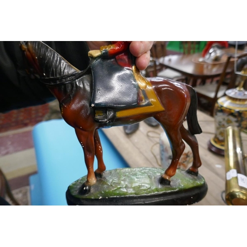 266 - Figurine of the Queen riding a horse together with a Black and White Whisky figurine