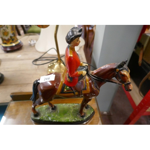 266 - Figurine of the Queen riding a horse together with a Black and White Whisky figurine