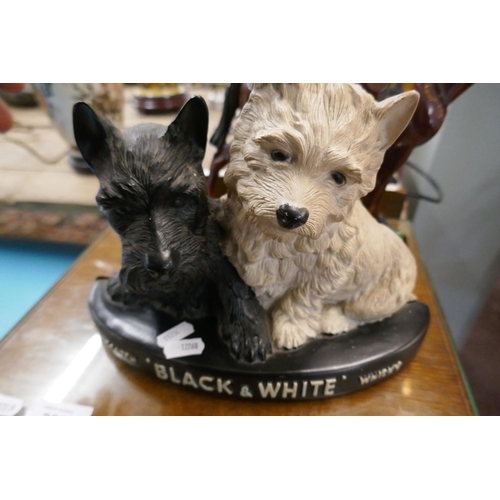 266 - Figurine of the Queen riding a horse together with a Black and White Whisky figurine