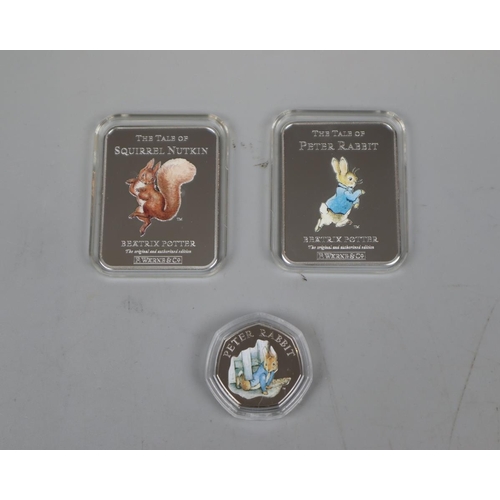 86 - 2 x The Tales of Peter Rabbit silver plated ingots together with Peter Rabbit 50 pence coin