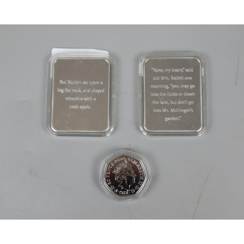 86 - 2 x The Tales of Peter Rabbit silver plated ingots together with Peter Rabbit 50 pence coin