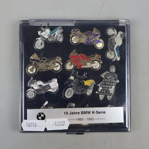 97 - Boxed set of 10 Jahre BMW K-Serie pin badges together with a metal bike clock and 2 metal plane cloc... 