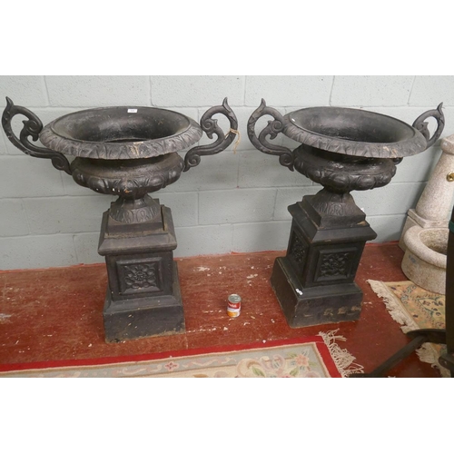 324 - Pair of cast iron urns on plinths - Approx height: 105cm