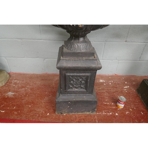 324 - Pair of cast iron urns on plinths - Approx height: 105cm