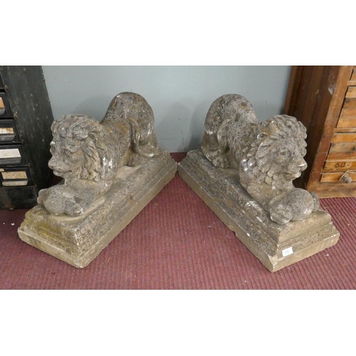 370 - Pair of stone lions with ball