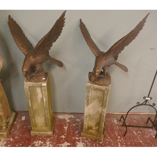 391 - Pair of cast iron eagles on stone plinths - Approx height: 135cm