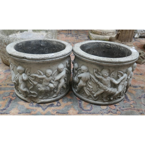 413 - Pair of stone planters adorned with cherubs