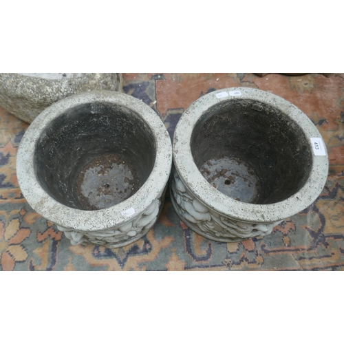 413 - Pair of stone planters adorned with cherubs