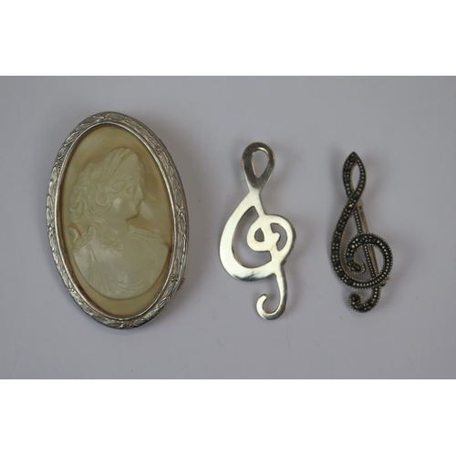 77 - 2 silver music note brooches together with a silver framed brooch