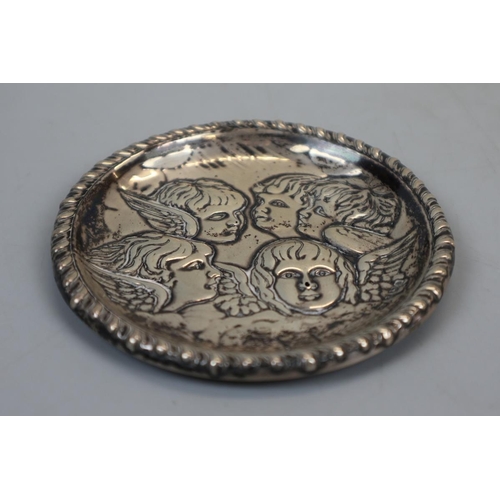 10 - Hallmarked silver pin tray adorned with cherubs