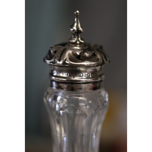 25 - Cut glass condiment bottles with hallmarked silver tops