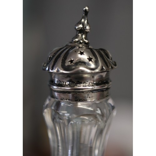 25 - Cut glass condiment bottles with hallmarked silver tops