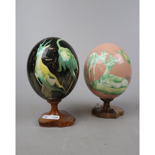 179 - 2 ostrich eggs hand decorated and signed Shelly Rowe - Approx height: 21cm