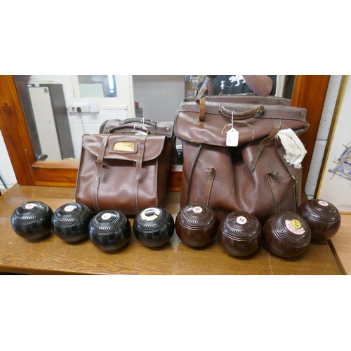 389 - 2 leather cases together with bowling woods